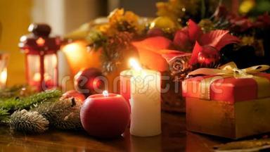 为圣诞节装饰的桌子上燃烧红白蜡烛的特写镜头。 冬天的完美背景
